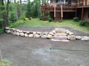 Boulder retaining wall with steps
