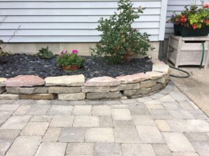 brick pavers and natural stone raised bed