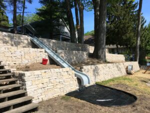 Tri-level Retaining wall with slide by Twin Oaks Landscaping